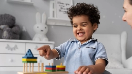 Baby boy enjoying game at the best day care school twinnienursery school uk