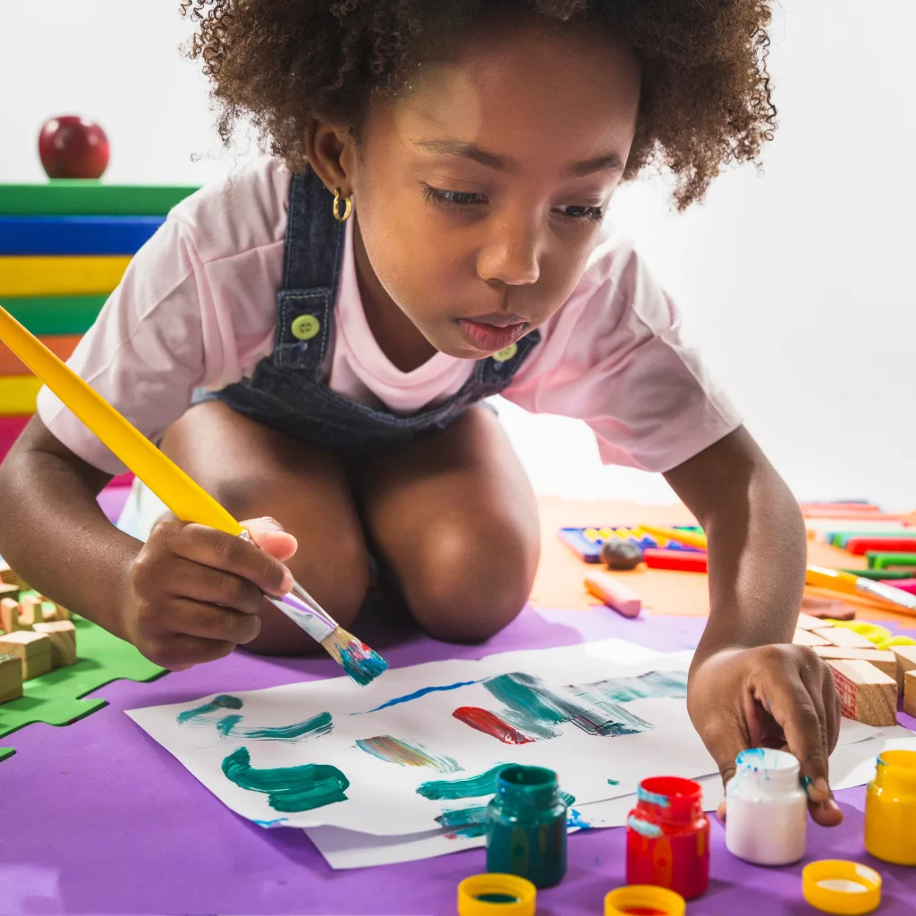 girl-painting-paper-studio.webp