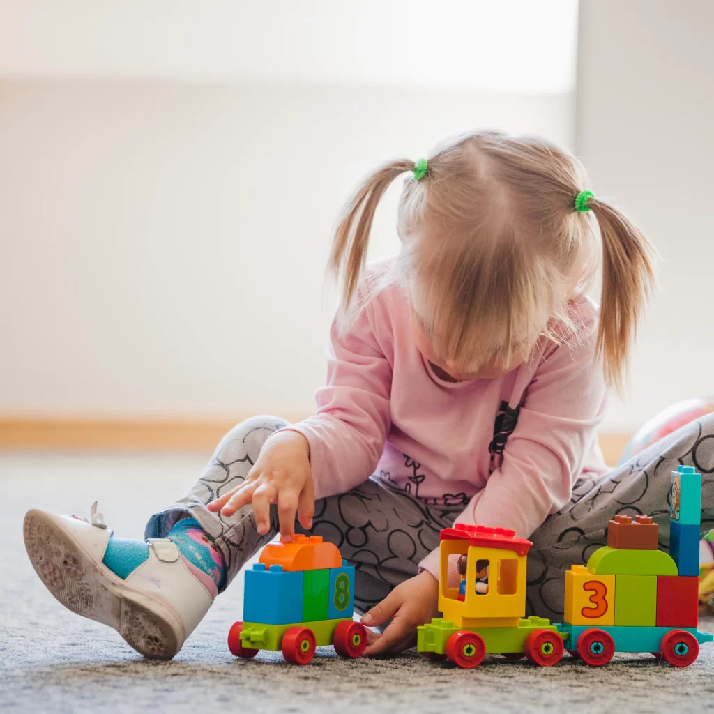 girl-with-ponytails-playing-with-toy
